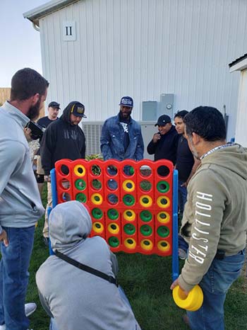 Environmental Management, Inc. staff at appreciation day playing giant connect 4